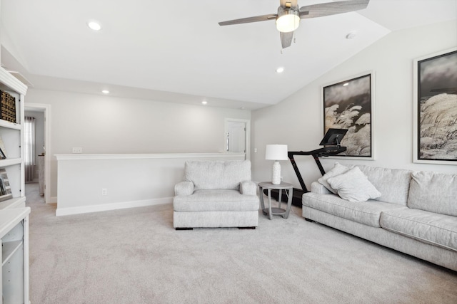 carpeted living room with ceiling fan and vaulted ceiling