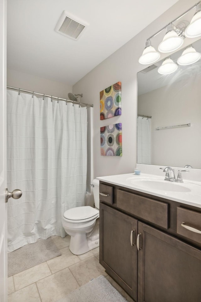 bathroom with a shower with curtain, vanity, toilet, and tile patterned flooring