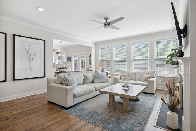 living room featuring crown molding, dark hardwood / wood-style flooring, and ceiling fan