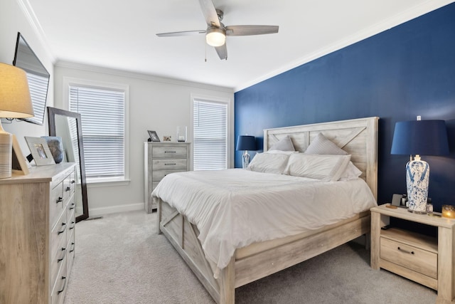 carpeted bedroom with ceiling fan, ornamental molding, and multiple windows