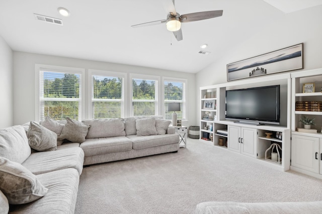 carpeted living room featuring ceiling fan and vaulted ceiling