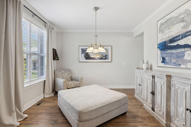 sitting room featuring crown molding, plenty of natural light, and dark wood-type flooring