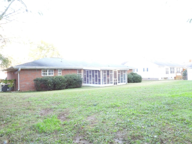 exterior space with a lawn and a sunroom