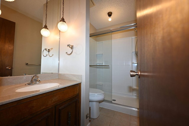 bathroom featuring tile patterned floors, an enclosed shower, vanity, a textured ceiling, and toilet