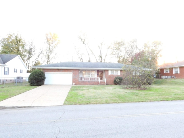 ranch-style house with a front yard and a garage