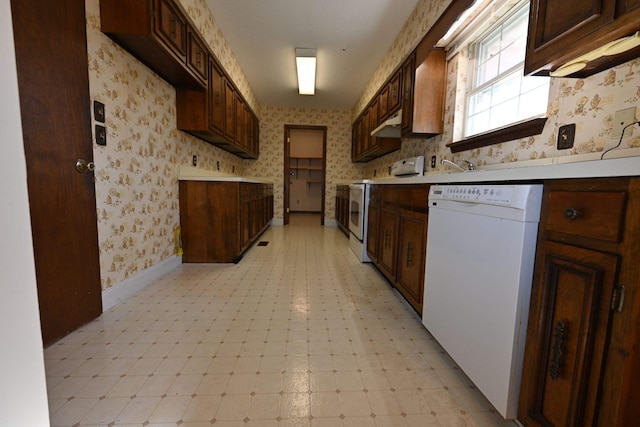 kitchen featuring dark brown cabinets and white appliances