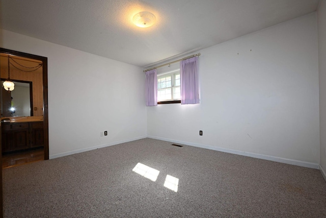 unfurnished room featuring carpet