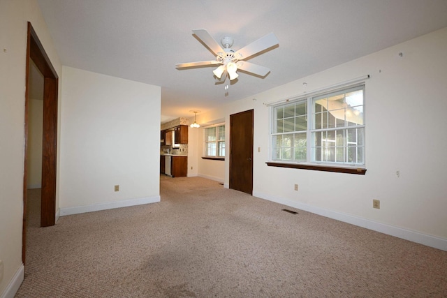 carpeted empty room with ceiling fan