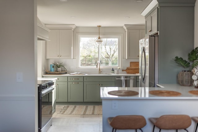 kitchen featuring pendant lighting, sink, a kitchen breakfast bar, and appliances with stainless steel finishes