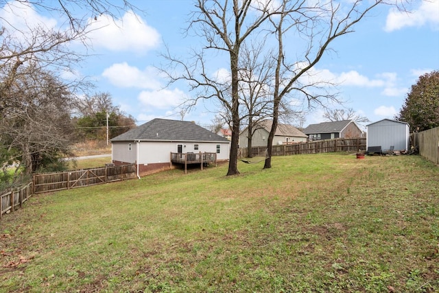 view of yard featuring a shed and a wooden deck