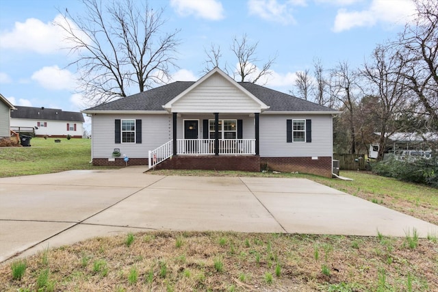 single story home featuring covered porch and a front lawn