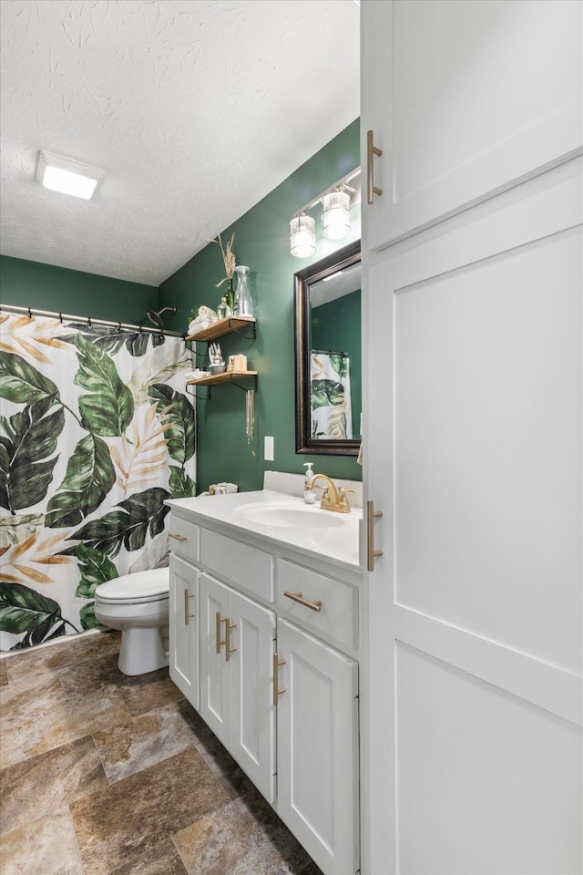 bathroom with vanity, a shower with curtain, a textured ceiling, and toilet