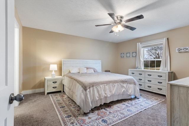 bedroom with carpet flooring, ceiling fan, and a textured ceiling