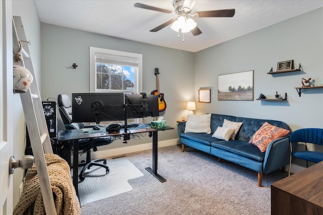 office space featuring light carpet, a textured ceiling, and ceiling fan