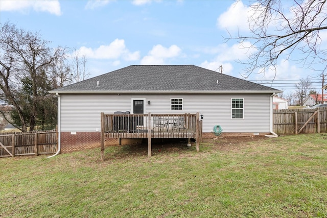 rear view of property featuring a lawn and a wooden deck