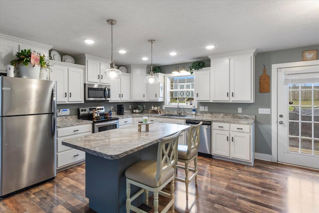 kitchen with white cabinets, a center island, and stainless steel appliances