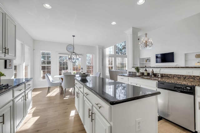 kitchen with dishwasher, a center island, light hardwood / wood-style floors, and a wealth of natural light