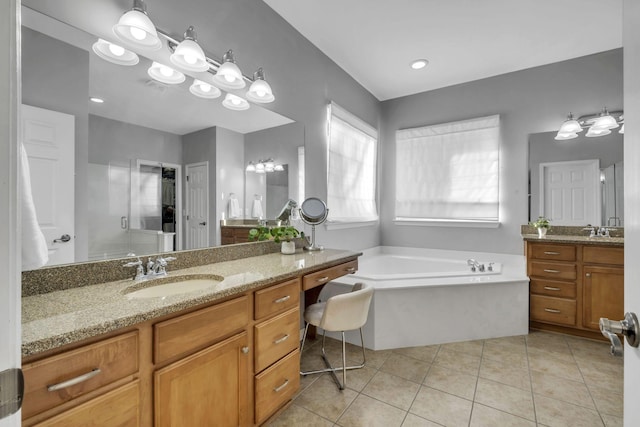 bathroom featuring tile patterned flooring, vanity, and shower with separate bathtub