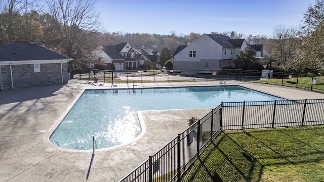 view of swimming pool with a yard and a patio area