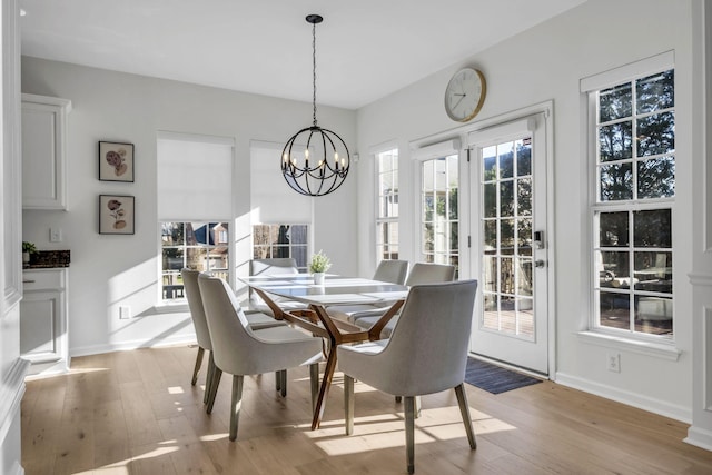 dining space featuring a chandelier and light hardwood / wood-style flooring