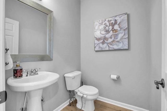 bathroom featuring hardwood / wood-style floors and toilet