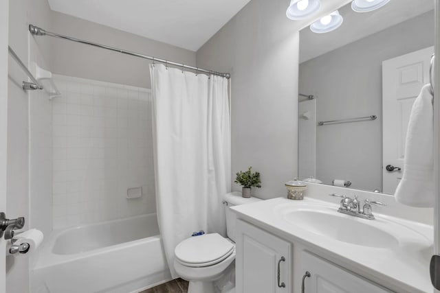 full bathroom featuring hardwood / wood-style flooring, shower / tub combo with curtain, vanity, and toilet