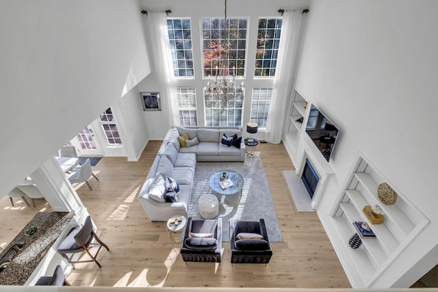 living room featuring light hardwood / wood-style floors and a high ceiling