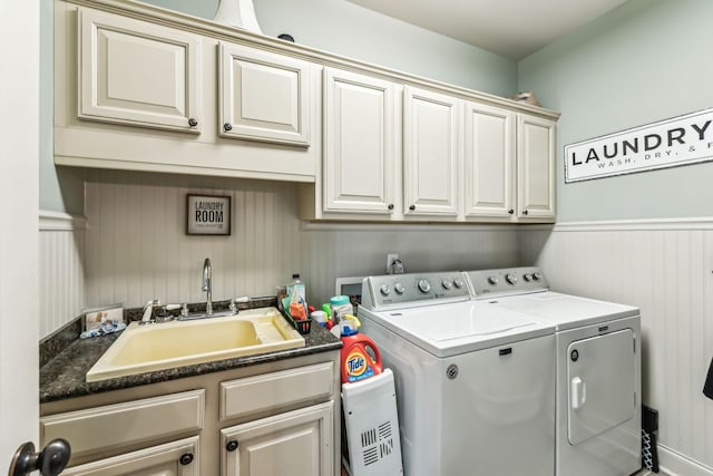 laundry room with washer and clothes dryer, cabinets, and sink