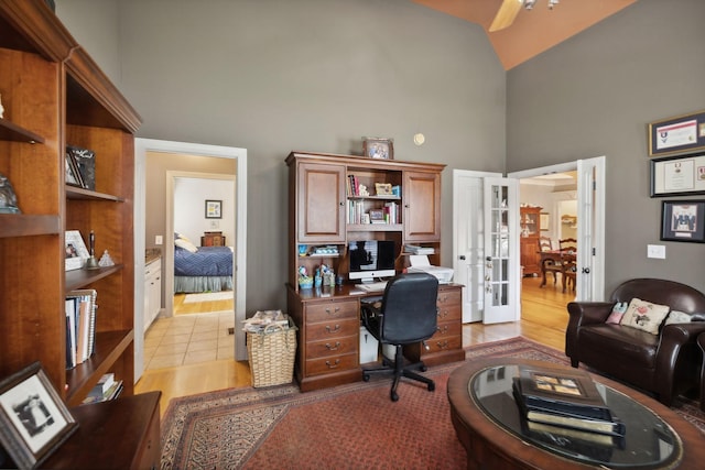 office area with ceiling fan, french doors, high vaulted ceiling, and light hardwood / wood-style floors