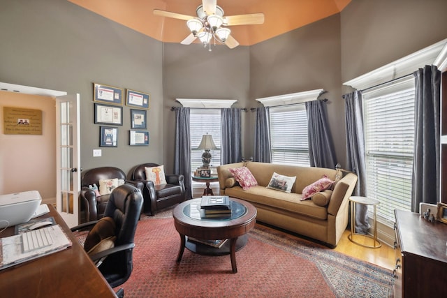 living room featuring ceiling fan, plenty of natural light, hardwood / wood-style floors, and french doors