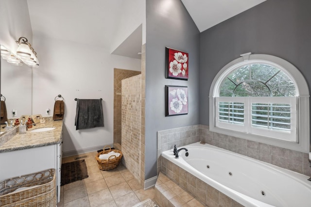 bathroom featuring tile patterned floors, vanity, vaulted ceiling, and shower with separate bathtub