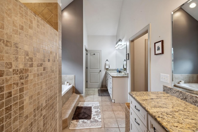 bathroom featuring vanity, tiled bath, and tile patterned floors