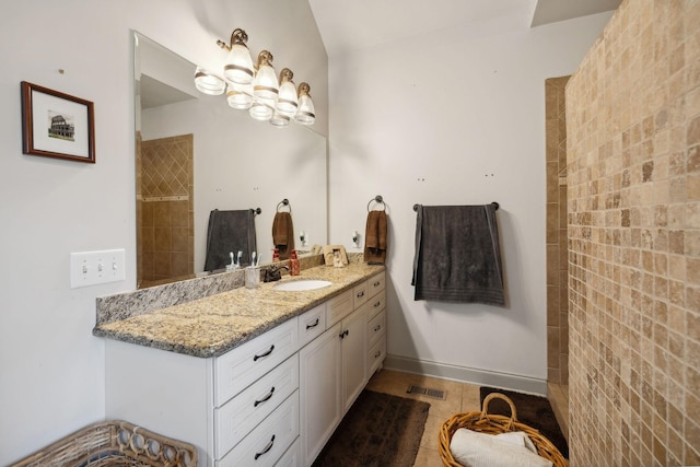 bathroom featuring tile patterned flooring and vanity