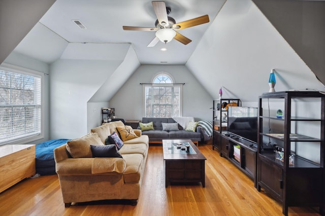 living room with light hardwood / wood-style flooring, ceiling fan, and lofted ceiling