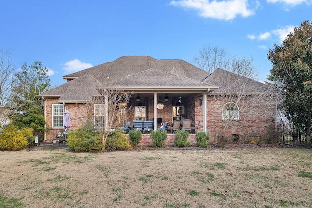 rear view of house featuring a lawn, an outdoor living space, and a patio