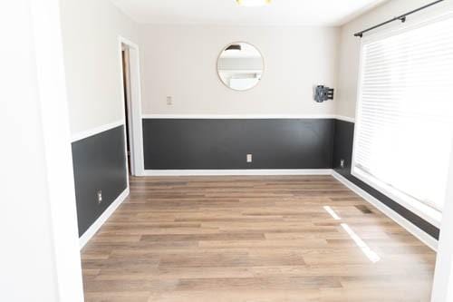 spare room with wood-type flooring