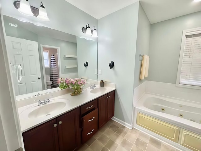 bathroom featuring a bathing tub, vanity, and toilet