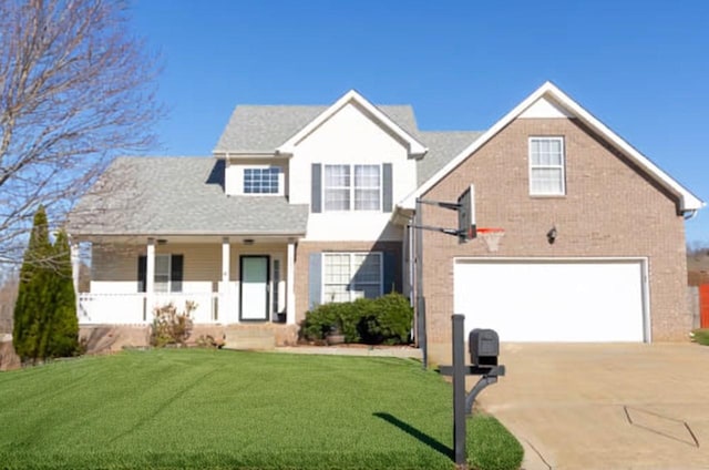 front of property with a front yard, a porch, and a garage