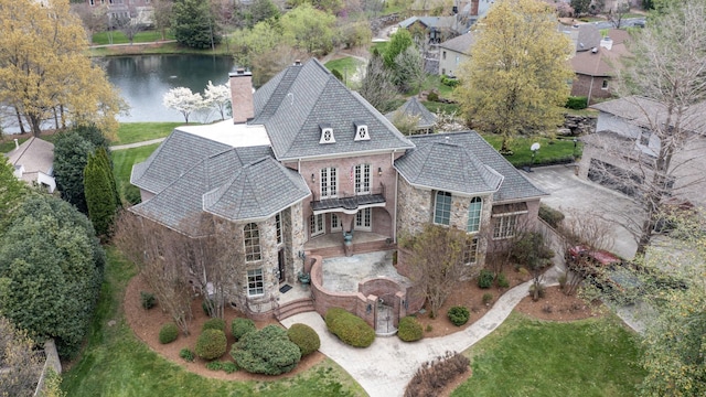 birds eye view of property with a water view