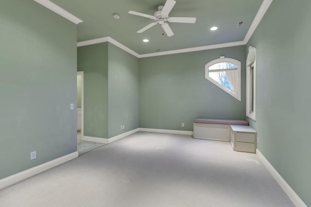 carpeted spare room with ceiling fan and ornamental molding