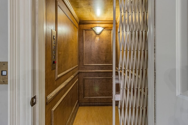 room details featuring hardwood / wood-style floors, elevator, and wooden walls