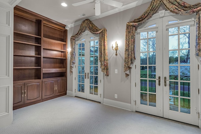 doorway to outside with ceiling fan, light colored carpet, and french doors