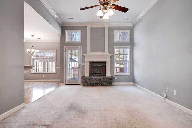 unfurnished living room featuring crown molding, a towering ceiling, a fireplace, ceiling fan with notable chandelier, and hardwood / wood-style flooring