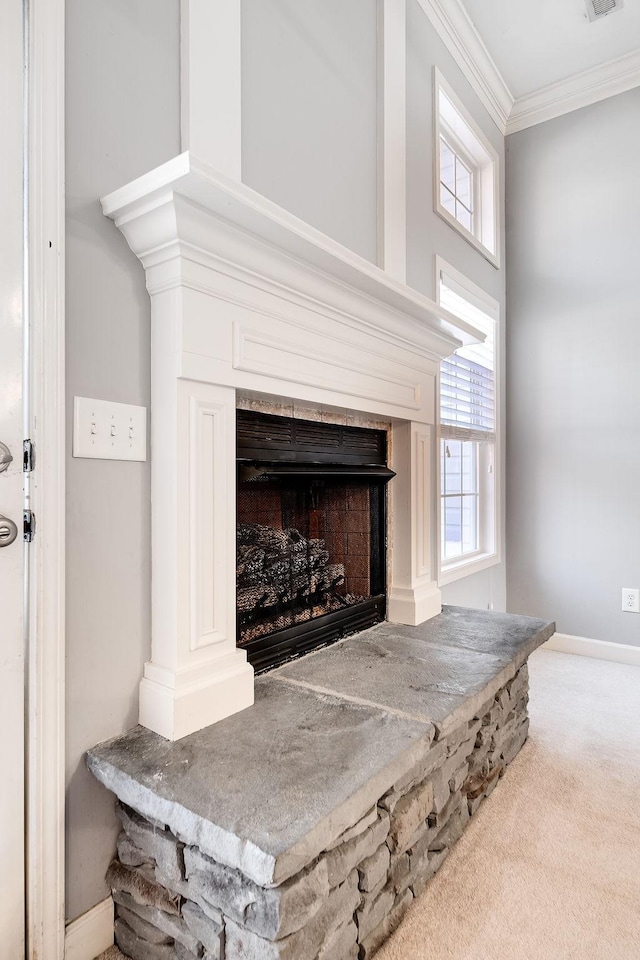 details with a fireplace, carpet floors, and ornamental molding