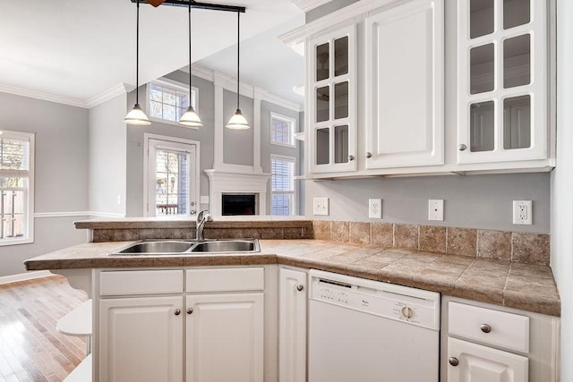 kitchen with white cabinetry, sink, crown molding, white dishwasher, and wood-type flooring