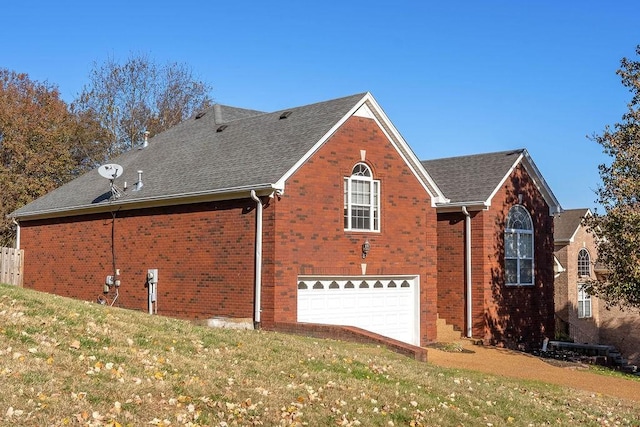 view of home's exterior featuring a yard and a garage