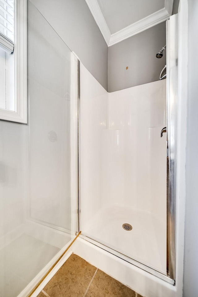 bathroom featuring tile patterned flooring, walk in shower, and crown molding