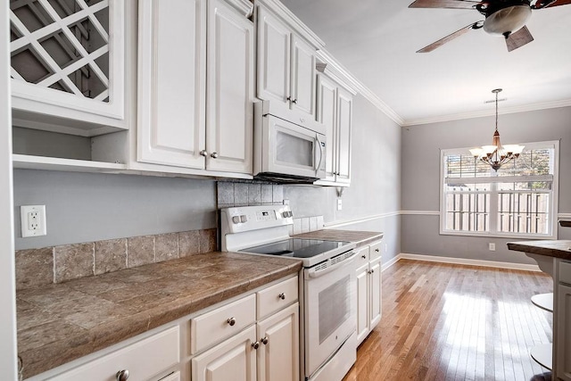 kitchen with white cabinetry, light wood-type flooring, white appliances, and crown molding