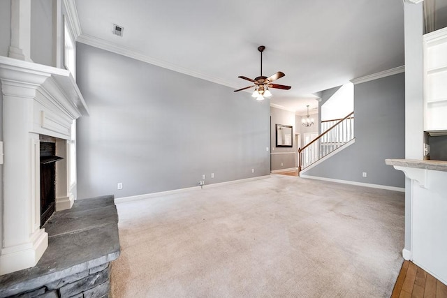 unfurnished living room featuring ceiling fan with notable chandelier, carpet floors, and ornamental molding