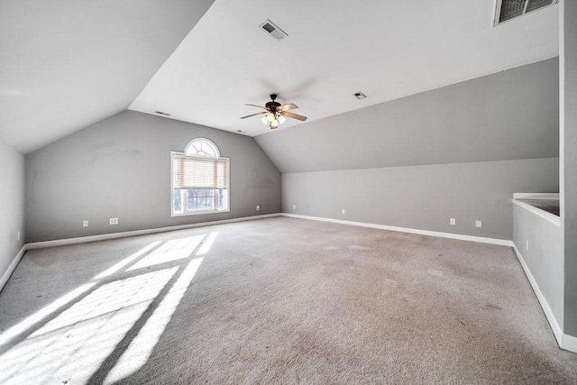 additional living space featuring light colored carpet, vaulted ceiling, and ceiling fan